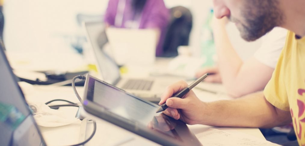 Office boy with tablet in hands