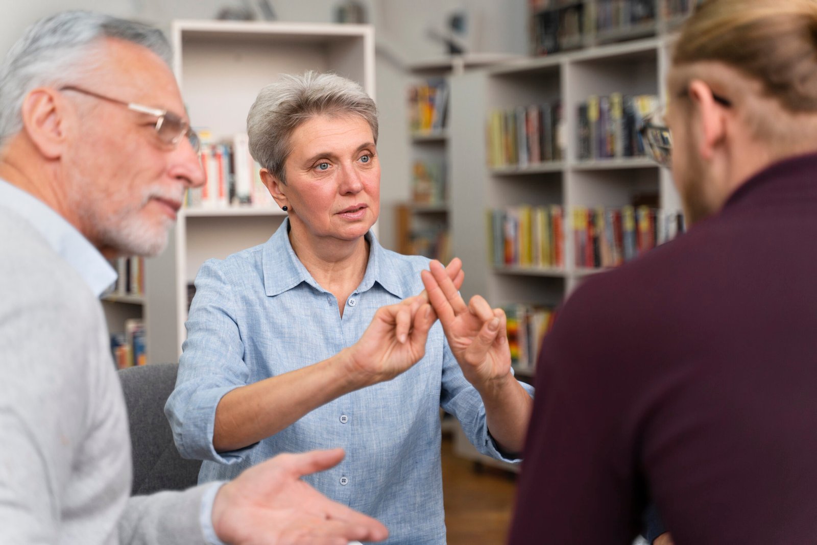 ASL interpreter facilitating communication between individuals during a professional interpreting session