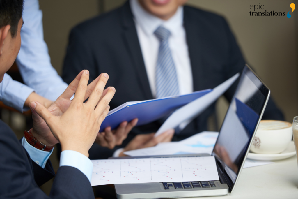 Business professionals reviewing regulatory documents to identify translation errors that can delay global market entry