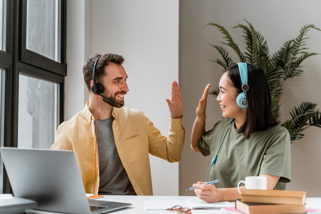Two professionals using headsets during an over-the-phone interpreting session, enabling real-time multilingual communication