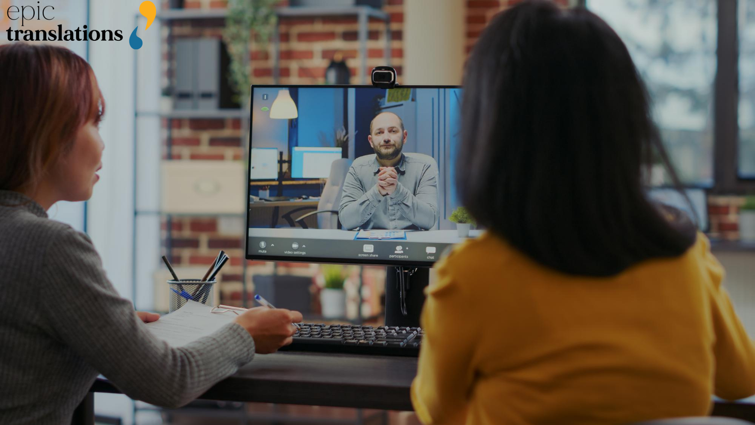 Video Remote Interpreting Services 2 Two professionals participate in a video remote interpreting (VRI) session, viewing a remote interpreter on a computer screen during an institutional meeting